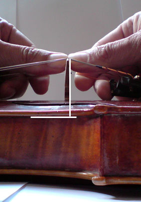 This is how one carefully positions a bridge in violin building